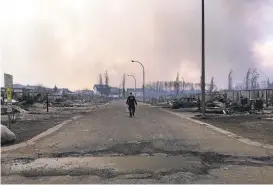  ?? ALBERT RCMP/AGENCE FRANCE-PRESSE VIA GETTY IMAGES ?? More than 80,000 people were evacuated from Fort McMurray, Alberta. The fire burned more than 1,600 homes and other structures in the city.