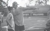  ?? SOFIE BRANDT THE HARTFORD COURANT ?? Tim Boyle, former Xavier High School and Uconn quarterbac­k explains a pattern to Jonathan Morales Jr. during a workout this week at Boyle’s alma mater.
Boyle will be with the Lions in training camp later this summer.