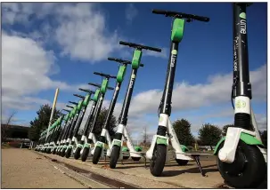  ?? (Arkansas Democrat-Gazette/Thomas Metthe) ?? Lime scooters sit ready for use Wednesday in Clinton Presidenti­al Park in Little Rock. City officials are trying to balance safety concerns with state legislatio­n and the potential for more revenue.