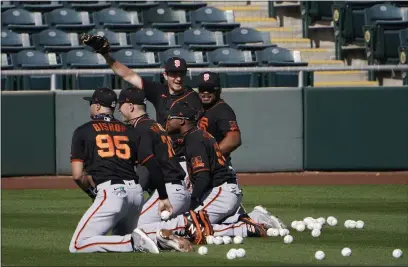  ?? PHOTOS BY JAE C. HONG — THE ASSOCIATED PRESS ?? San Francisco Giants players take part in a drill during the team’s spring training workout in Scottsdale, Ariz., on Friday.