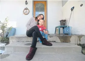  ?? Jeremy Papasso, Daily Camera ?? Heatherwoo­d neighborho­od resident Leesah Patt and her 3-year-old son, Gavin Jr., sit on their front porch Tuesday in Gunbarrel. One of several residents of the neighborho­od who received letters offering to lease minerals, Patt opposes the possibilit­y of nearby fracking and is working to organize opposition to the plan.