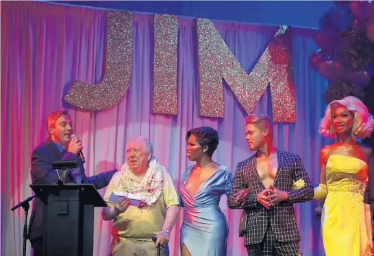  ?? CHRIS SWEDA/CHICAGO TRIBUNE ?? Chicago drag pioneer Jim Flint, second from left, is honored during an 80th birthday celebratio­n for the Baton Show Lounge owner at Park West on July 27.