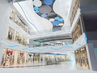  ??  ?? The three-level shopping mall is designed to be true to its environmen­t — its overall ambience is characteri­zed by cool hues and curvilinea­r architectu­ral details.