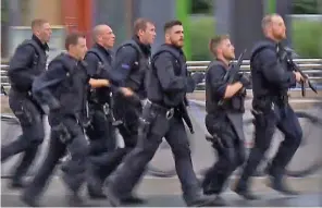  ??  ?? Ready for battle: Police officers arrive at the shopping centre