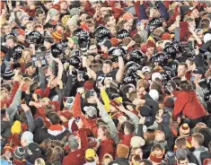  ?? REESE STRICKLAND/ USA TODAY SPORTS ?? Students and fans rushed the field Saturday night after Iowa State toppled previously unbeaten and No. 6 West Virginia 30-14.