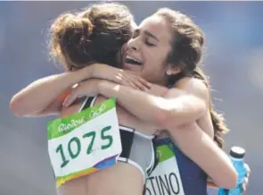  ??  ?? New Zealand’s Nikki Hamblin, left, and Team USA’s Abbey D’Agostino embrace after competing at the 2016 Summer Olympics in Rio. Associated Press file photos