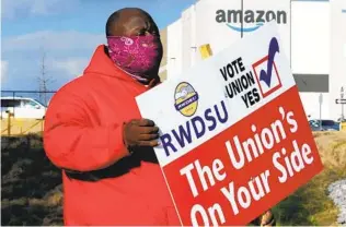  ?? JAY REEVES AP ?? Michael Foster of the Retail, Wholesale and Department Store Union outside an Amazon facility in Bessemer, Ala. Nearly 6,000 Amazon warehouse workers are voting on whether to unionize.