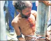  ?? RAHUL MONDAL/HT PHOTO ?? Locals tied a man suspected of being a childlifte­r to an electric pole before beating him to death in Malda district in West Bengal on Wednesday.