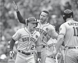  ?? AP ?? The Astros’ Alex Bregman, from left, celebrates his home run with Carlos Correa and Evan Gattis in the eighth inning of Game 4 of an AL Division Series on Monday in Boston.