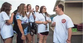  ??  ?? Ben Halvorson, 18, converses with fellow seniors about their college plans during Senior Day at Bartlett High School on Friday. Halvorson will be the first student in Bartlett City Schools to have Down Syndrome and graduate with a general education...