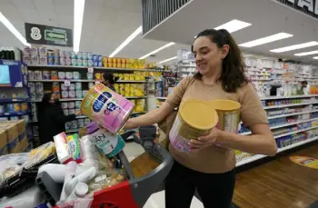  ?? Gregory Bull, The Associated Press ?? Michelle Saenz of Santee, Calif., buys baby formula at a grocery store Tuesday in Tijuana, Mexico. As the baby formula shortage continues in the United States, some parents are opting to cross the border into Mexico, where the shelves are still stocked with options to feed their babies.
