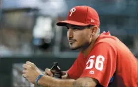  ?? RICK SCUTERI — THE ASSOCIATED PRESS ?? Phillies pitcher Zach Eflin looks on during a game in Arizona last Wednesday. Eflin is glad to be back with the team after an ‘administra­tive’ demotion to ease the Phils’ roster crunch.