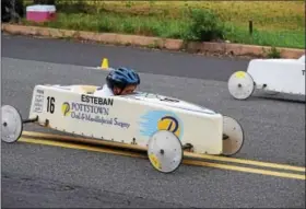  ?? MARIAN DENNIS – DIGITAL FIRST MEDIA ?? Racers zoom down Wilson Street Saturday as they compete for the top spot in their division during the Pottstown Soap Box Derby.