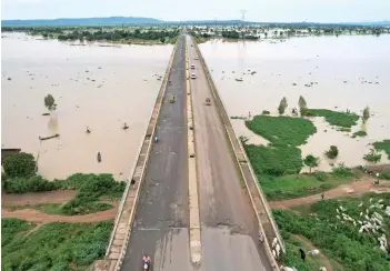  ?? — AFP photo ?? This aerial view shows local residents crossing the Numan bridge while driving to a safer grounds away from the rising waters in Numan Community of Adamawa State – North East Nigeria.