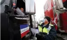  ?? Photograph: Blair Gable/Reuters ?? Police hand out informatio­n sheets and speak to demonstrat­ors as truckers and supporters continue to protest coronaviru­s vaccine mandates, in Ottawa, on Wednesday.