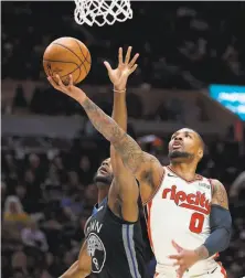  ?? Craig Mitchelldy­er / Associated Press ?? Trail Blazers guard Damian Lillard (right) shoots around the Warriors’ Alec Burks during the first half in Portland, Ore.