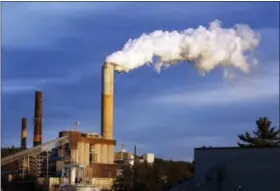 ?? THE ASSOCIATED PRESS ?? A plume of steam billows from the coal-fired Merrimack Station in Bow, N.H. President Barack Obama on Monday will unveil the final version of his unpreceden­ted regulation­s clamping down on carbon dioxide emissions from existing U.S. power plants.