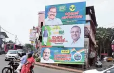  ?? VISHNU PRATHAP ?? Last phase: Three huge flex boards put up on a building in Kottayam by the three leading fronts.