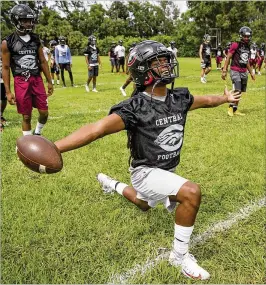  ?? PALM BEACH POST ?? Palm Beach Central defensive back Akeem Dent, a top prospect committed to FSU, takes part in warmup stretches on the first day of practice on July 30.