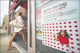  ?? GENE J. PUSKAR — THE ASSOCIATED PRESS ?? A help wanted sign hangs on the door of a Target store in Uniontown, Pa., earlier this month. Hundreds of thousands of Americans likely applied for unemployme­nt benefits last week, a high level of job insecurity that reflects economic damage from the coronaviru­s outbreak.