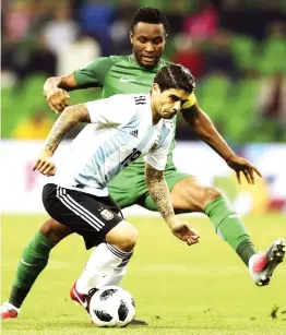  ??  ?? Ever Banega of Argentina vies for the ball with John Obi Mikel of Nigeria during an internatio­nal friendly match at Krasnodar Stadium on November 14, 2017 in Krasnodar, Russia