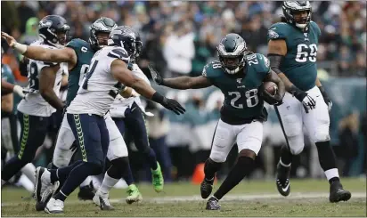  ?? MICHAEL PEREZ — THE ASSOCIATED PRESS ?? Eagles running back Jay Ajayi, seen against Seattle last week, isn’t the back who ran for three 200-yard games in 2016any more. But the beat-up Birds’ offense is hoping a return to Miami Sunday could get more production out of the newly re-acquired back.