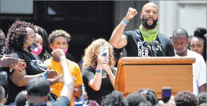  ?? Timothy D. Easley The Associated Press ?? As Tamika Palmer, left, Breonna Taylor’s mother, looks on Thursday, rapper Common speaks to a crowd in Frankfort, Ky.