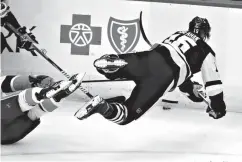  ?? Associated Press ?? ■ Pittsburgh Penguins' Riley Sheahan (15) collides with New York Islanders' Anthony Beauvillie­r in the first period of an NHL hockey game Saturday in Pittsburgh.