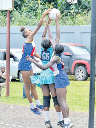  ?? FILE PHOTOS ?? Denbigh High School Goal Shooter Ramona Halstead (centre), rises above Obonnor Wallacs (right) and Jada Greenwood from Gaynstead, to catch a ball during the All-Island ISSA Netball Finals held at the Manchester High School field. Denbigh High School defeated Gainstead High School 22-15.