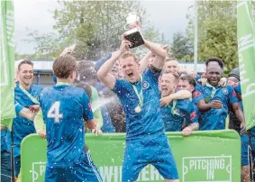  ?? ?? Chris Ovenden lifts the trophy after Marlow defeated Leatherhea­d 3-1 in Sunday's play-off final. All photos: Stuart McAlister.