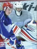  ?? PETER LEE, RECORD STAFF ?? Kitchener Rangers goalie Luke Richardson braces to stop a shot during practice at the Aud on Thursday.