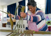  ??  ?? Niki Sturgess in the early stages of weaving a wahakura.