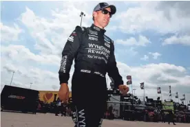  ?? GETTY IMAGES ?? Matt Kenseth walks through the Kansas Speedway garage area during practice Friday for his first NASCAR race this season.