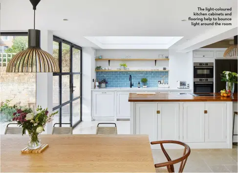  ?? ?? The light-coloured kitchen cabinets and flooring help to bounce light around the room