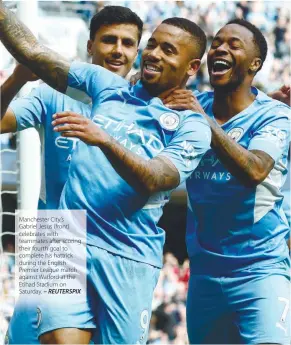  ?? – REUTERSPIX ?? Manchester City’s Gabriel Jesus (front) celebrates with teammates after scoring their fourth goal to complete his hattrick during the English Premier League match against Watford at the Etihad Stadium on Saturday.