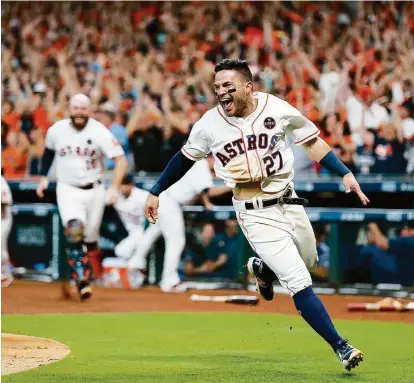  ?? Brett Coomer / Houston Chronicle ?? Jose Altuve gets the Astros’ celebratio­n started after he scored the game-winner on Carlos Correa’s double in the ninth inning of Saturday’s 2-1 win over New York in Game 2 of the ALCS.