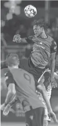  ??  ?? Phoenix Rising’s Kevon Lambert wins a battle for a header against El Paso's Yuma in the first half of their match at Casino Arizona Field in Tempe on Saturday.