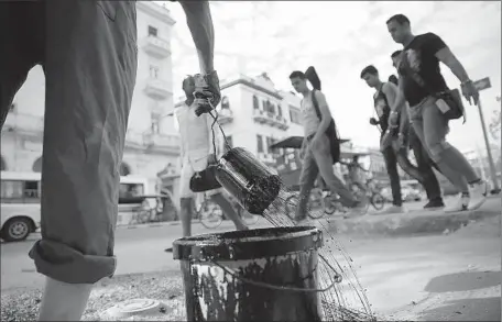  ?? Photog r aphs by Robert Gauthier
Los Angeles Times ?? STREET REPAIRS continue in the Prado area of Old Havana before President Obama’s arrival for a two- day visit with his family. Aides say Obama will speak forcefully on the issue of human rights and that he will meet with political dissidents and other community leaders.