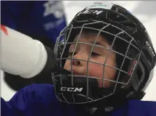  ?? KEVIN ADSHADE/THE NEWS ?? Zaxton Stone takes a water break during the Little Simmers hockey skills camp this week. At right,youngsters go through some skill-building at the six-week program.