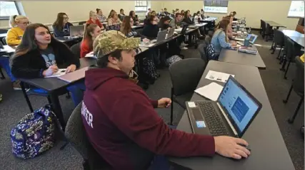  ?? Darrell Sapp/Post-Gazette ?? Taylor Howser, of Smock, Fayette County, pays attention as Alison Sakayuchi teaches a Health Assessment class at the Penn State University Fayette Campus. The addition of four-year programs at the university’s branch campuses is being considered as a reason for a decline in enrollment at schools in Pennsylvan­ia’s State System of Higher Education.