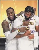  ?? Mike Ehrmann / Getty ?? Lebron James celebrates with Anthony Davis after the Lakers captured the NBA championsh­ip.
