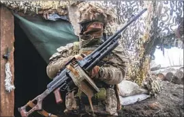  ?? Andriy Dubchak Associated Press ?? A UKRAINIAN soldier in the eastern region of Donetsk, where government forces have been battling Russia-backed separatist­s for nearly eight years.