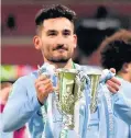  ??  ?? Ilkay Gundogan lifts the Carabao Cup