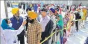  ??  ?? People wait in line for screening at Golden Temple in Amritsar on Wednesday. SAMEER SEHGAL/HT PHOTO