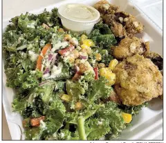  ?? Arkansas Democrat-Gazette/CELIA STOREY ?? A heaping portion of Kale Salad With Cajun Chickpeas comes with a side, in this case batter-fried cauliflowe­r.