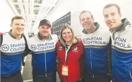  ??  ?? Tracy Davison, a volunteer at the Grand Slam of Curling, is shown with her favourite curling rink, a team skipped by Alberta’s Brendan Bottcher (far right).