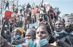  ?? AFP ?? Crowds cheer as Kenya’s President Uhuru Kenyatta attends the inaugurati­on of a hospital in a Nairobi slum.
