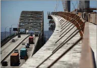  ?? (AP) ?? Traffic crosses the old Gerald Desmond Bridge next to its replacemen­t bridge under constructi­on in Long Beach, Calif., in 2018. The American Society of Civil Engineers gave America’s infrastruc­ture — roads, public transit and storm water systems — an overall grade of C- in a recent report.