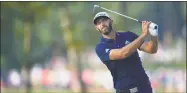  ?? Stuart Franklin / Getty Images ?? Dustin Johnson plays a shot on the 12th hole during the second round of the PGA Championsh­ip at Bellerive Country Club on Friday.