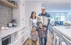  ??  ?? Melissa and Brian Finley with Paxton 3, Emmitt, 5, and baby Camden in the open kitchen. “I love it,” Melissa says.